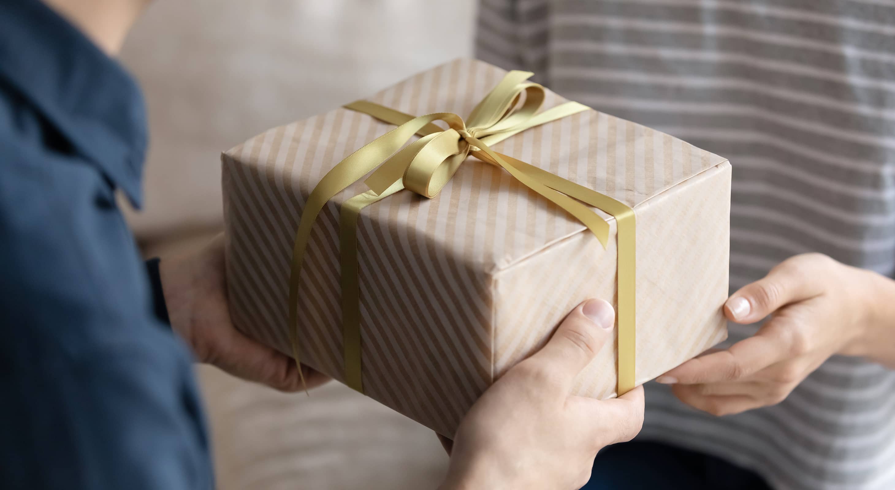 Man giving a woman a gift-wrapped present